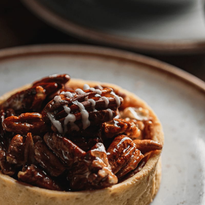 A delicious pecan tart with glaze on a plate