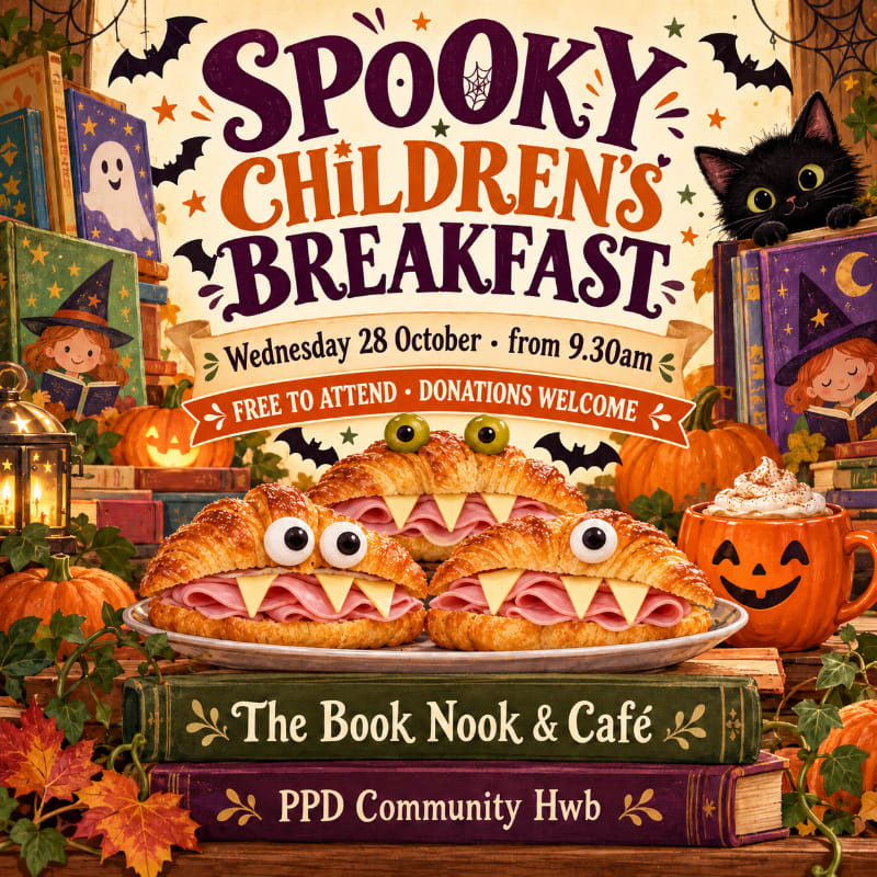 Three croissant sandwiches shaped like monsters sit on a plate in the foreground, while a festive Halloween-themed announcement with a black cat and pumpkins fills the background.