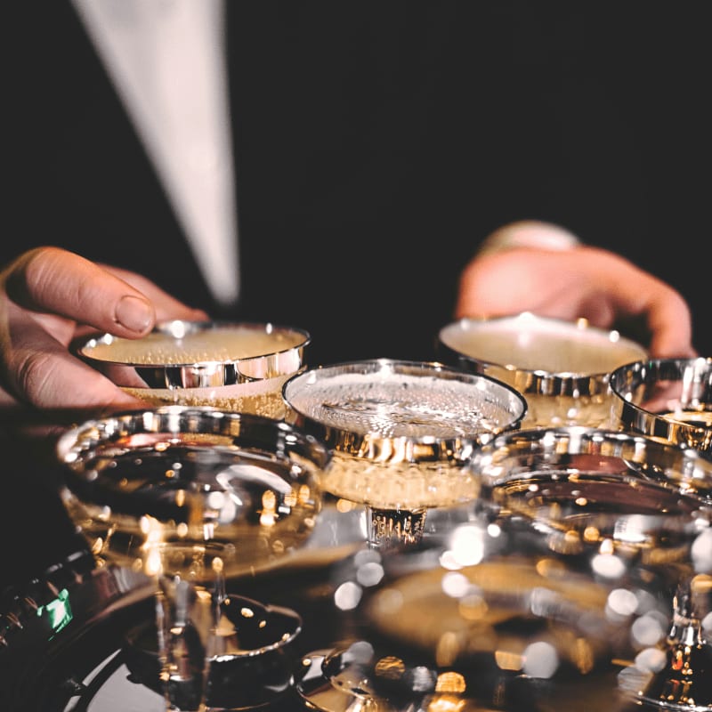 person standing beside martini glasses