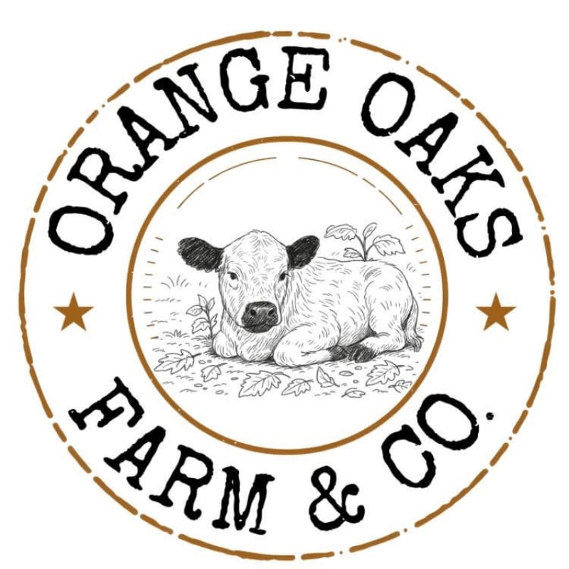 A sketch of a calf resting on leaves is centered within a circular border containing the text "ORANGE OAKS FARM & CO." against a white background.