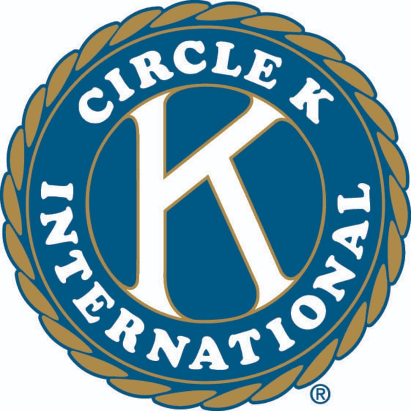 A white "K" is prominently displayed on a blue circle with "CIRCLE K INTERNATIONAL" written around it, all enclosed by a textured gold border.
