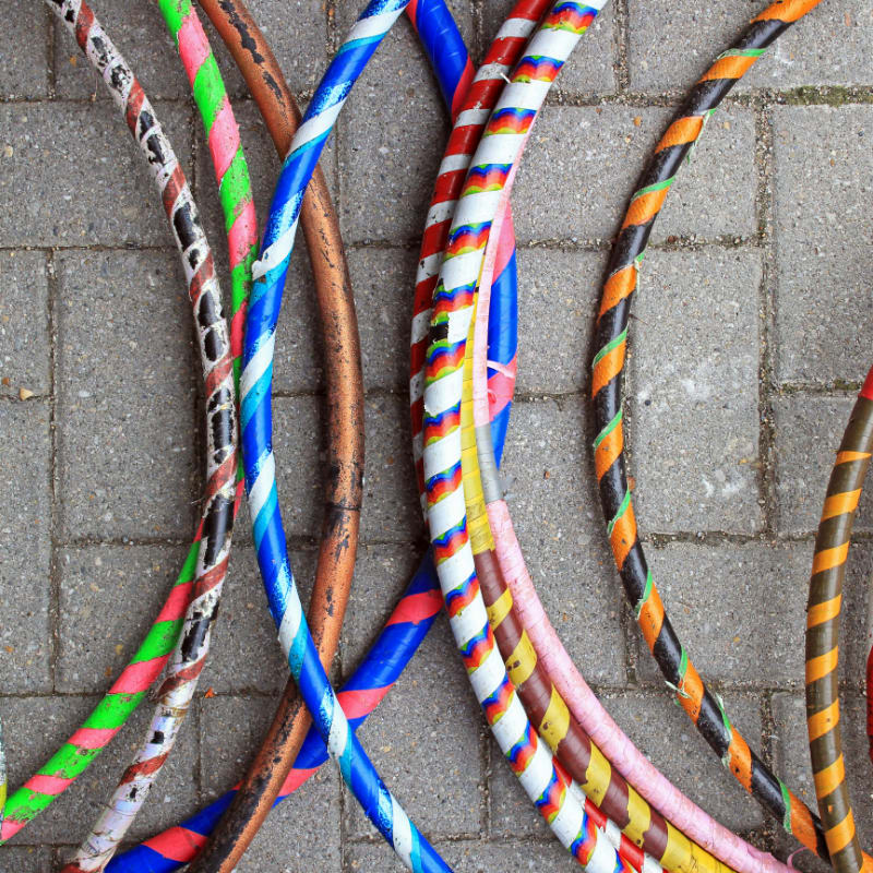 Colorful hula hoops lying on a stone path