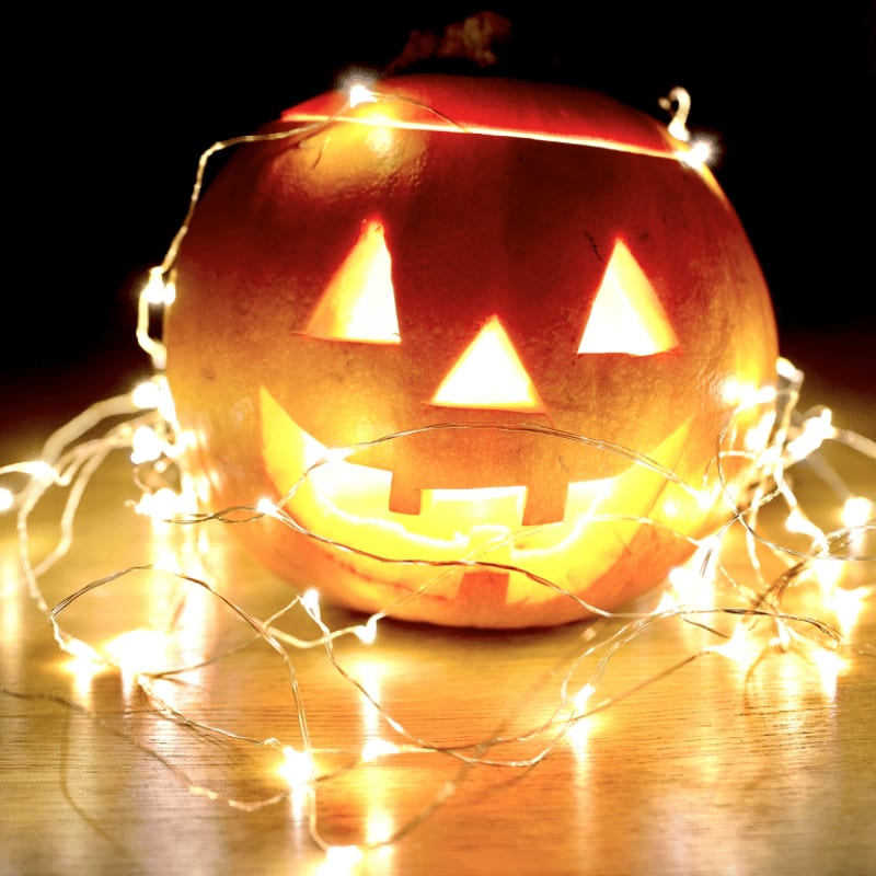 lighted string lights wrapped on Jack-O'-Lantern