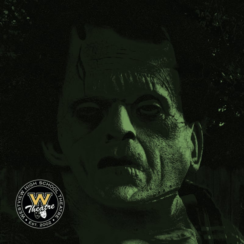 A close-up of a person in Frankenstein's monster makeup stands in the foreground against a dark, leafy background.