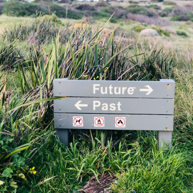 a sign in the middle of a grassy field