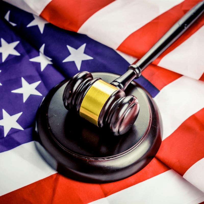 a judge's gavel on top of a flag