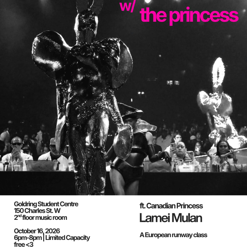 A person in a shimmering, sculptural silver outfit stands in the foreground against a dark background filled with a crowd of spectators.