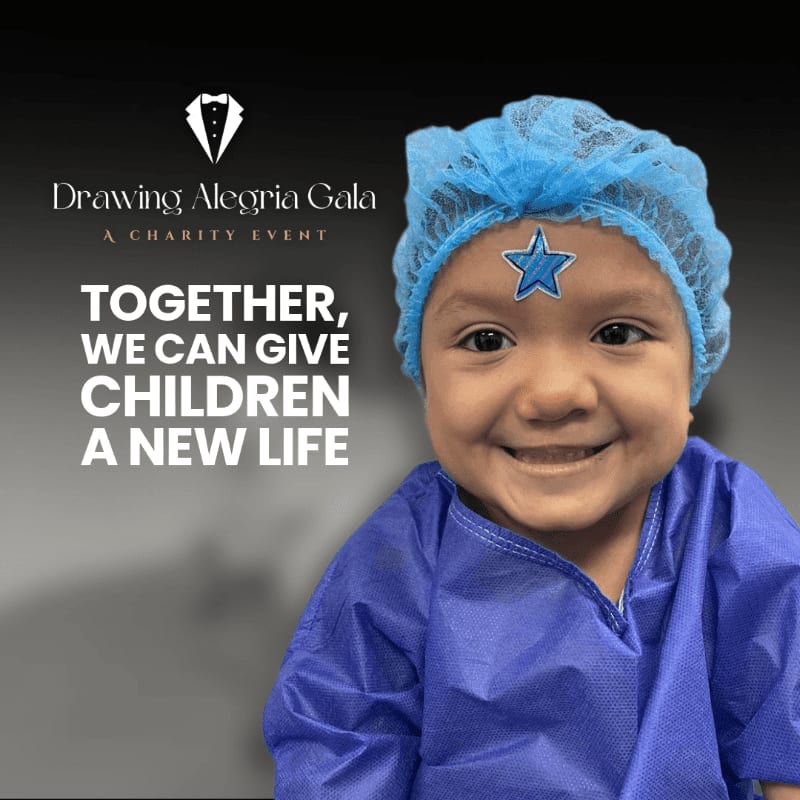 A smiling baby wearing a blue surgical cap and gown stands in the foreground against a dark background featuring text for the Drawing Alegria Gala charity event.