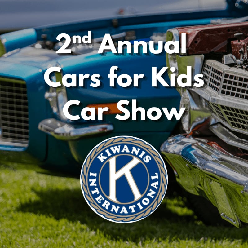 A Kiwanis International logo is superimposed on a close-up of two vintage cars at the 2nd Annual Cars for Kids Car Show, with green grass in the foreground and the cars' hoods and grilles filling the background.
