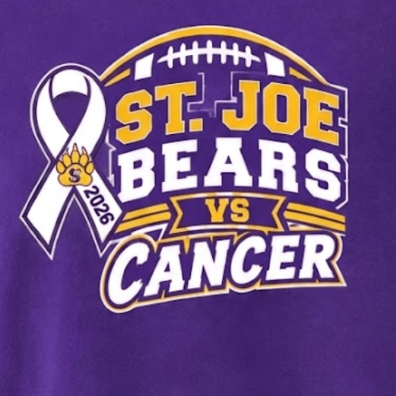 A white awareness ribbon and the text "ST. JOE BEARS VS CANCER" are set against a purple background with a football graphic.