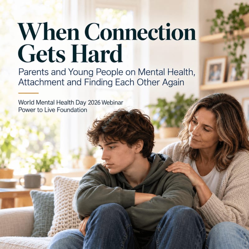 A woman places a comforting hand on the shoulder of a brooding teenage boy sitting on a couch in a bright, plant-filled living room.
