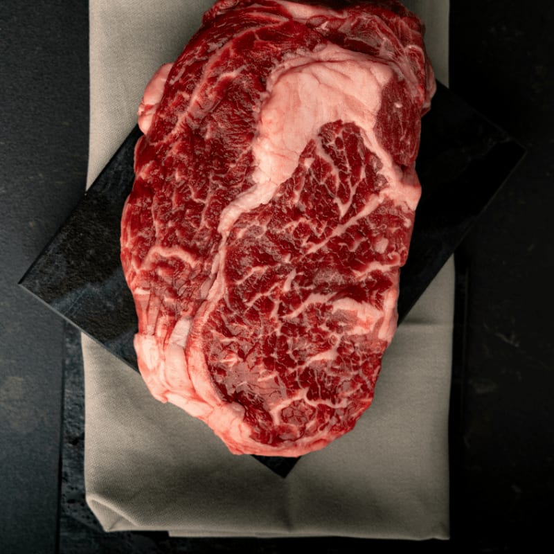 A piece of meat sitting on top of a piece of paper