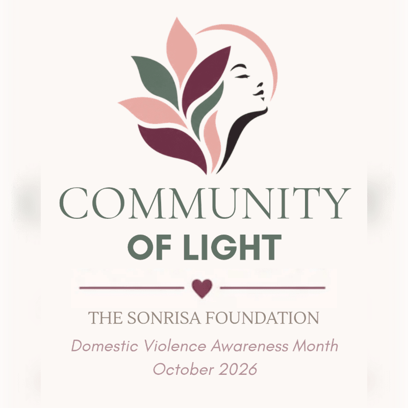 A stylized logo featuring a woman's profile and colorful leaves sits above the text "COMMUNITY OF LIGHT" and "THE SONRISA FOUNDATION" against a plain off-white background.