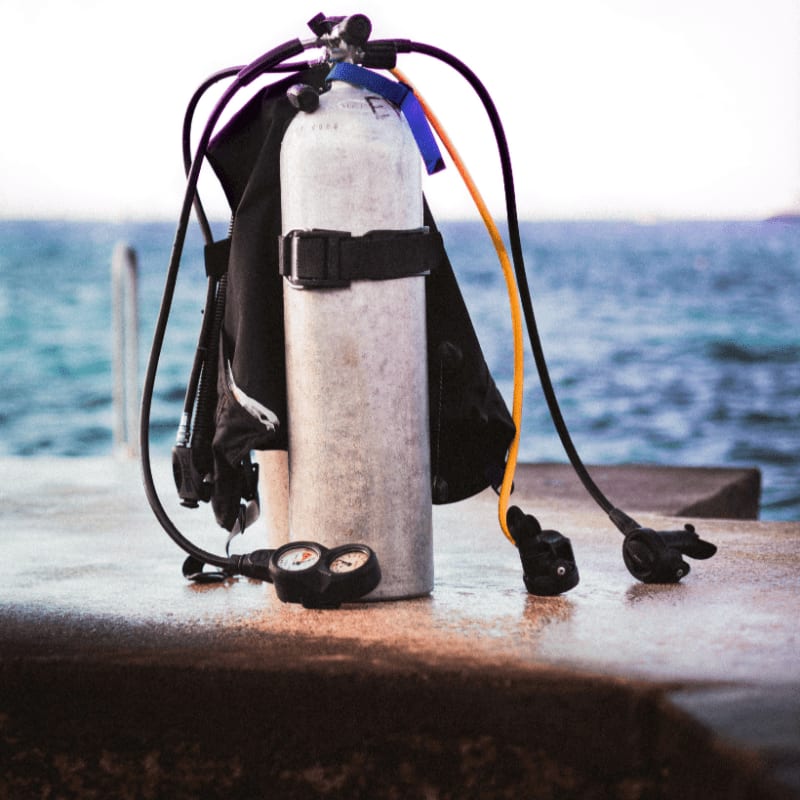 black and white fire extinguisher on brown concrete wall