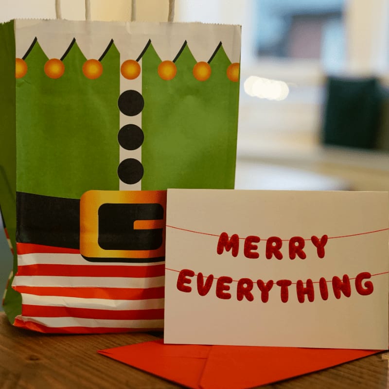 a christmas bag and a card sitting on a table