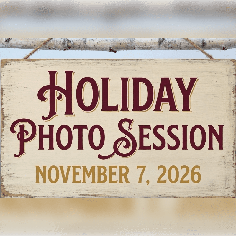 A wooden sign announcing a "Holiday Photo Session" on November 7, 2026, hangs from a birch branch against a blurred, neutral background.