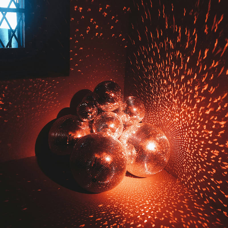 silver baubles on red wall