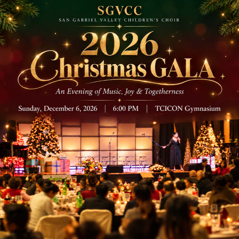 A crowd of guests sits at dinner tables in the foreground of a festive hall, while a singer performs on a stage decorated with Christmas trees in the background.
