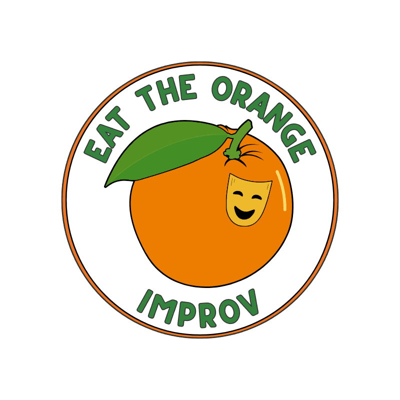 A circular logo featuring an orange with a smiling theater mask and a green leaf, surrounded by the text "EAT THE ORANGE IMPROV" against a plain white background.