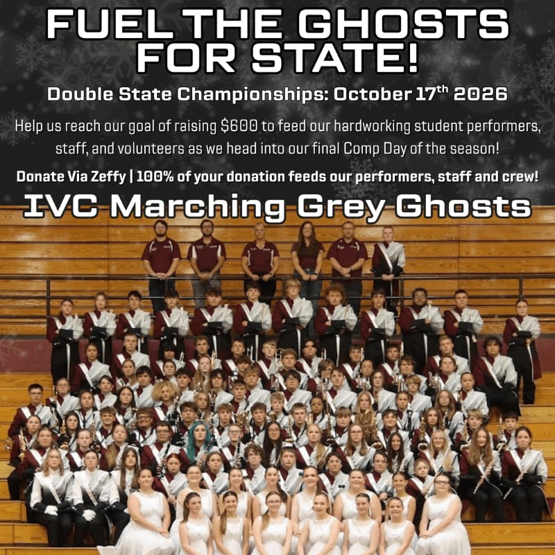 A large group of students in marching band uniforms poses for a photo in front of wooden bleachers, topped by a fundraising flyer for the IVC Marching Grey Ghosts.