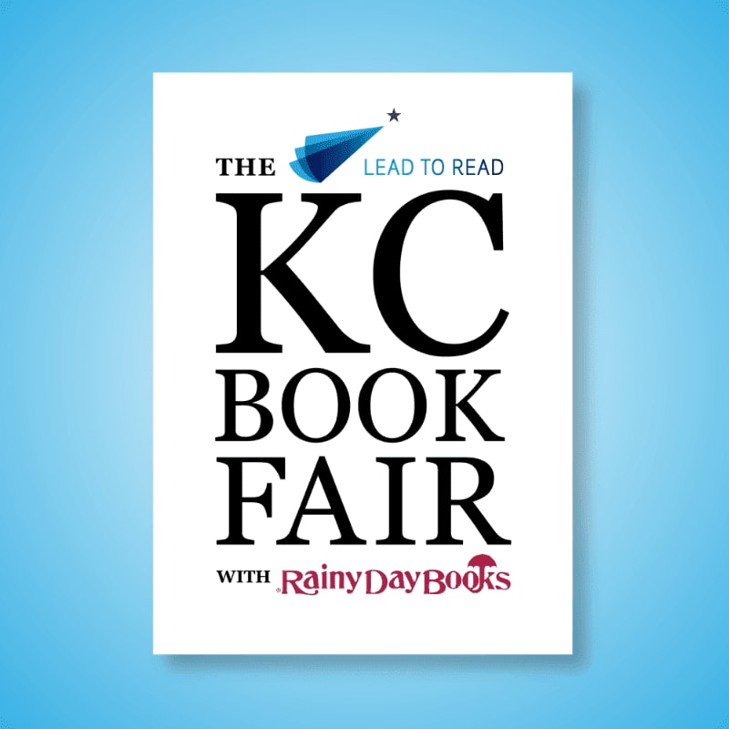 A white poster with bold black text announcing "THE KC BOOK FAIR" and a small blue logo with "LEAD TO READ" is centered against a bright blue, gradient background.