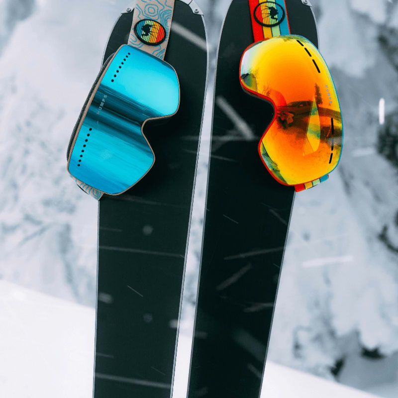 red and yellow snowboard on snow covered ground