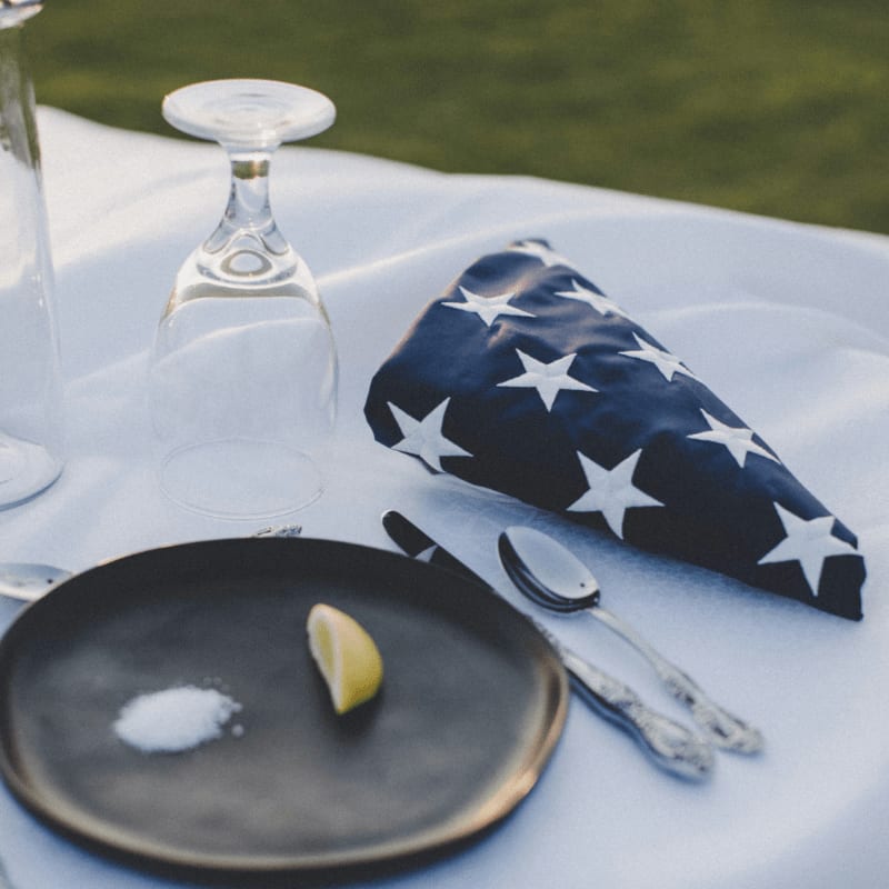stainless steel fork and bread knife on white ceramic plate