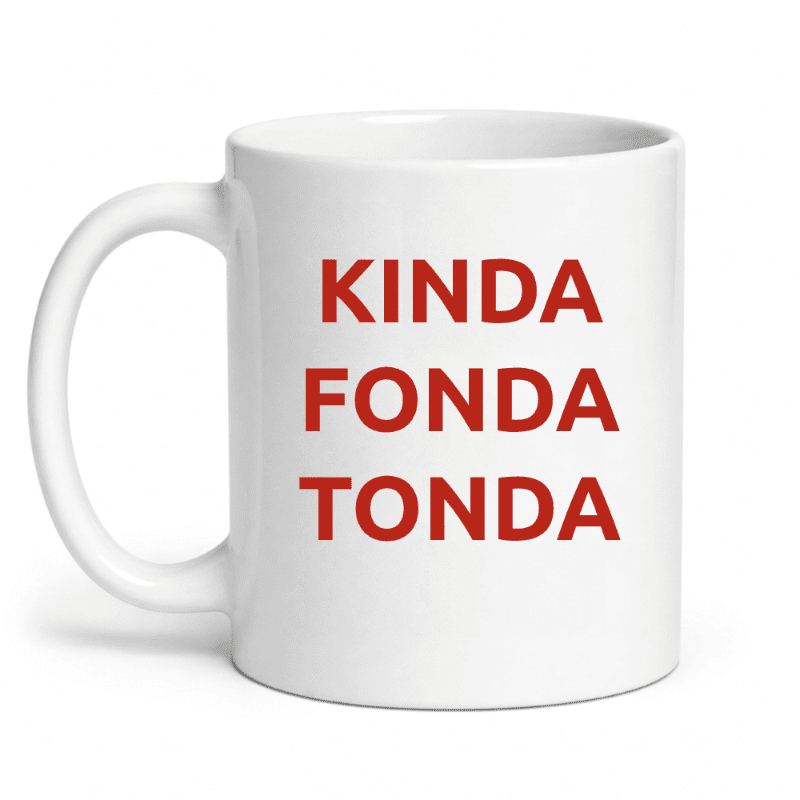 A white ceramic mug with the red text "KINDA FONDA TONDA" stands against a plain white background.