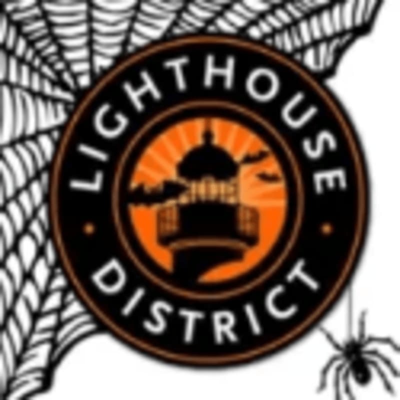 A circular "Lighthouse District" logo featuring a lighthouse silhouette is set against a background of a spiderweb and a small spider.