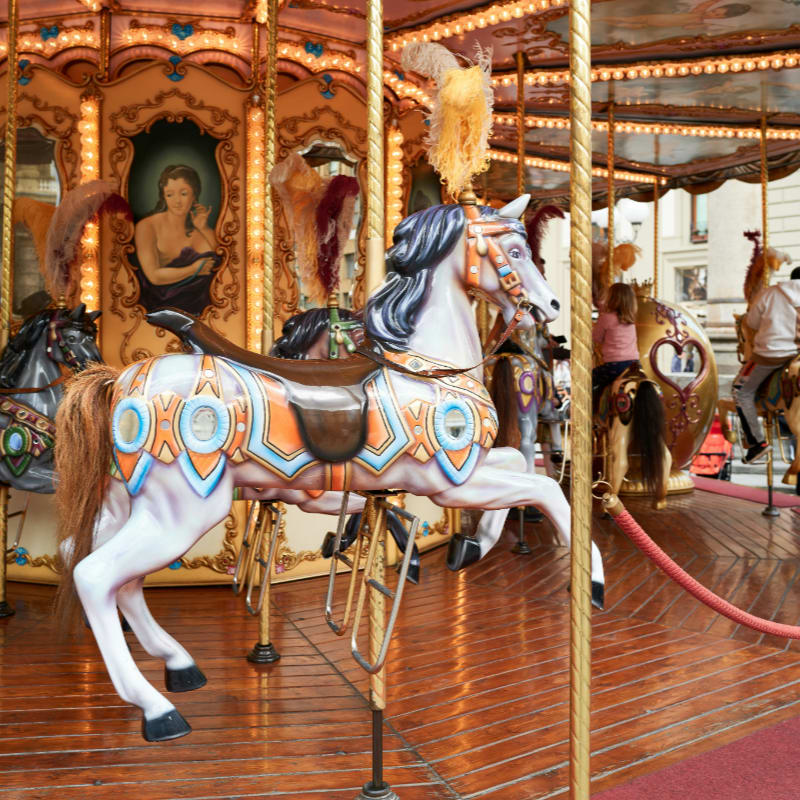 a merry go round with horses on a wooden floor