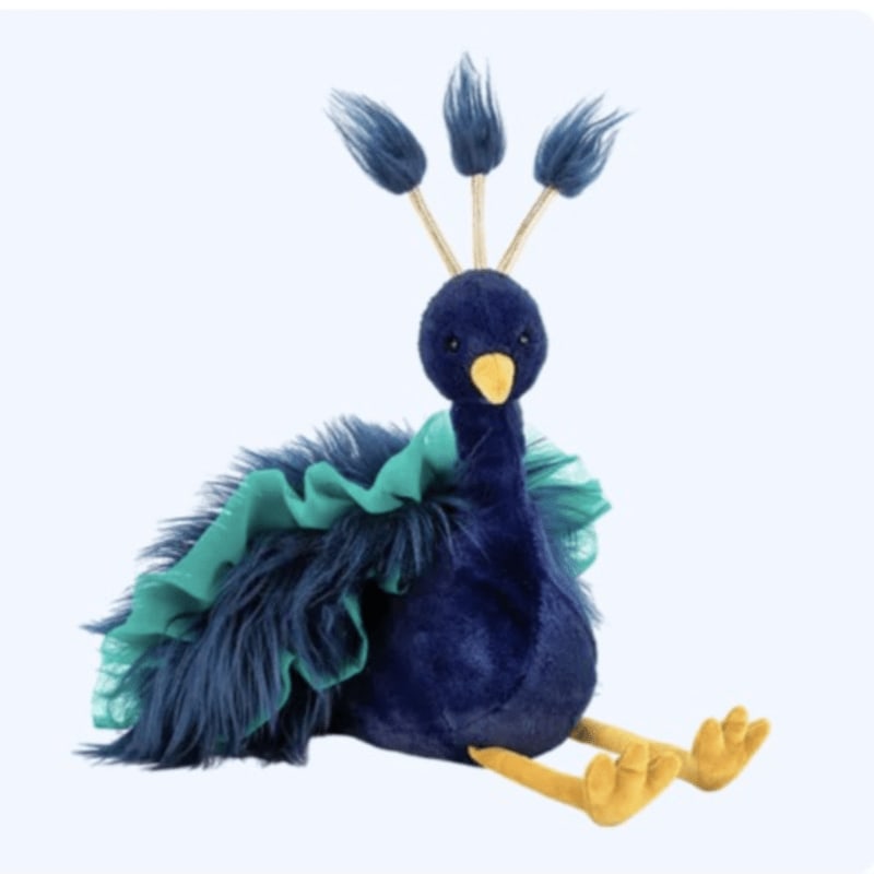 A plush blue peacock with a green ruffled collar sits against a plain white background.