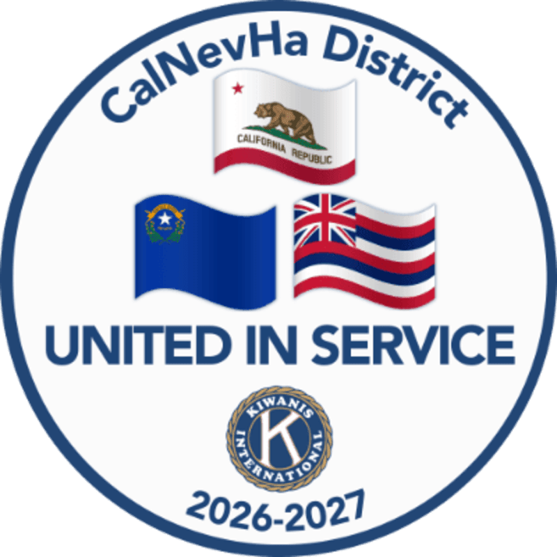 Three state flags and the Kiwanis International logo are centered within a blue circular border containing the text "CalNevHa District," "UNITED IN SERVICE," and "2026-2027" against a white background.