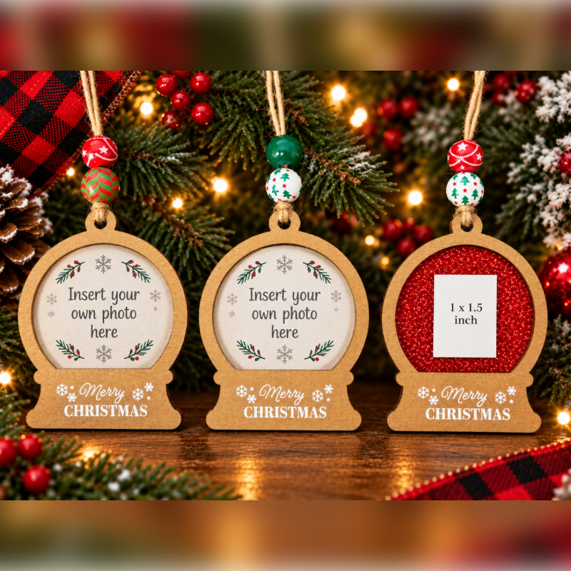 Three wooden Christmas ornaments with photo slots hang in the foreground against a background of festive pine branches, red berries, and twinkling lights.