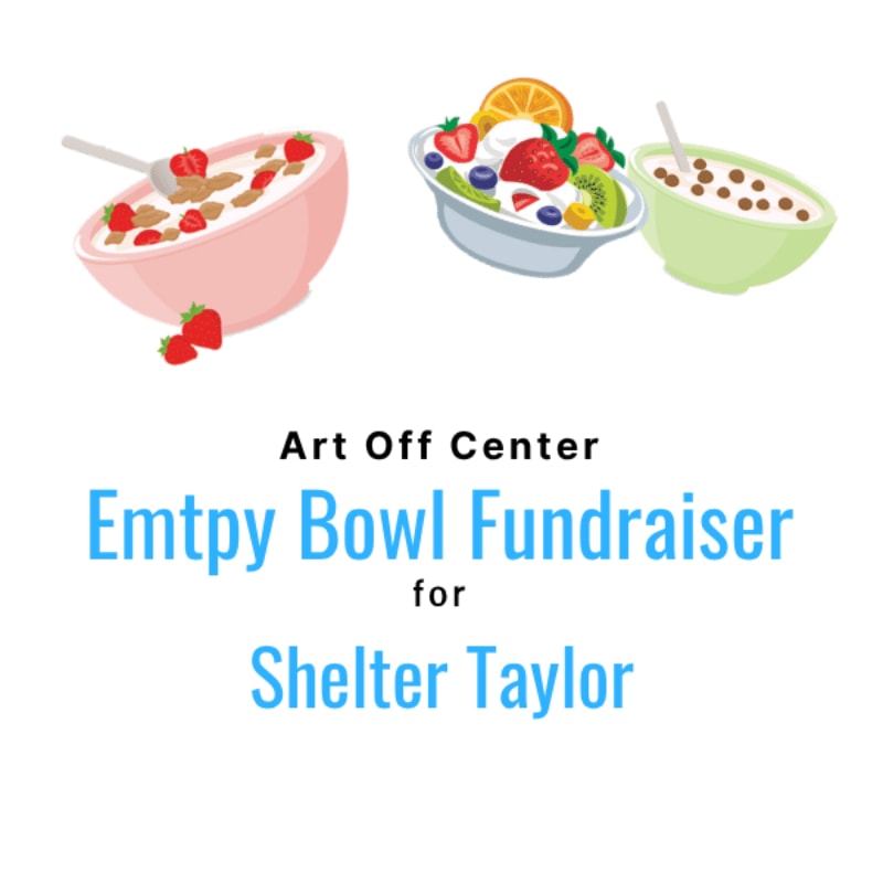 Several colorful ceramic bowls sit on a patterned tablecloth in a room with a blue wall.