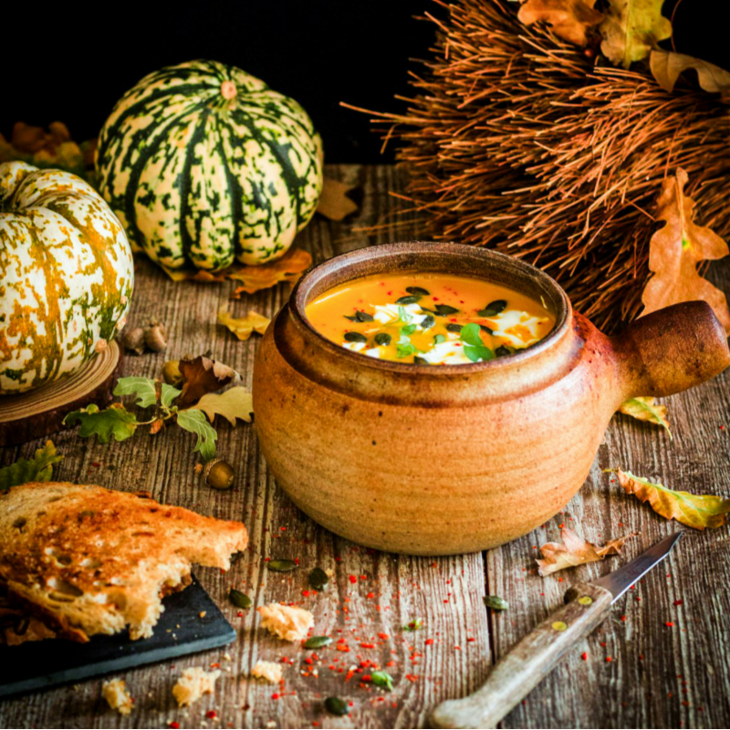 a bowl of soup on a wooden table