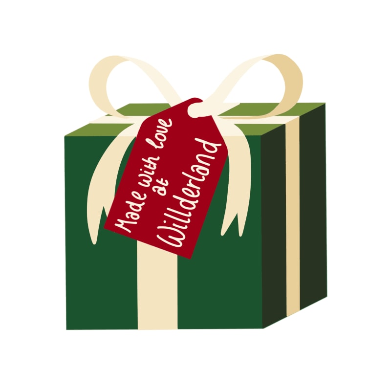 A green wrapped gift with a cream ribbon and a red tag reading "Made with love at Willderland" is set against a plain white background.