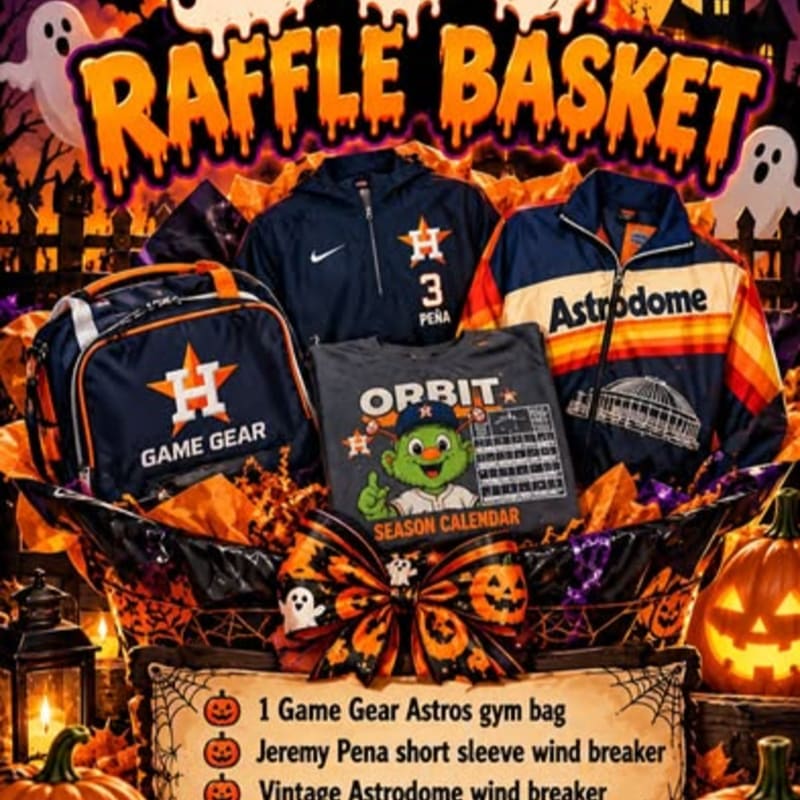 A raffle basket filled with Houston Astros themed apparel and gear sits against a spooky Halloween background featuring ghosts and pumpkins.