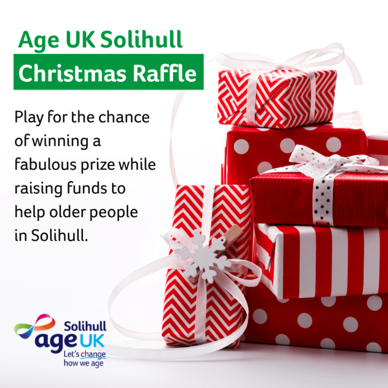 Text promoting the Age UK Solihull Christmas Raffle sits to the left of a stack of red and white patterned gift boxes against a plain white background.