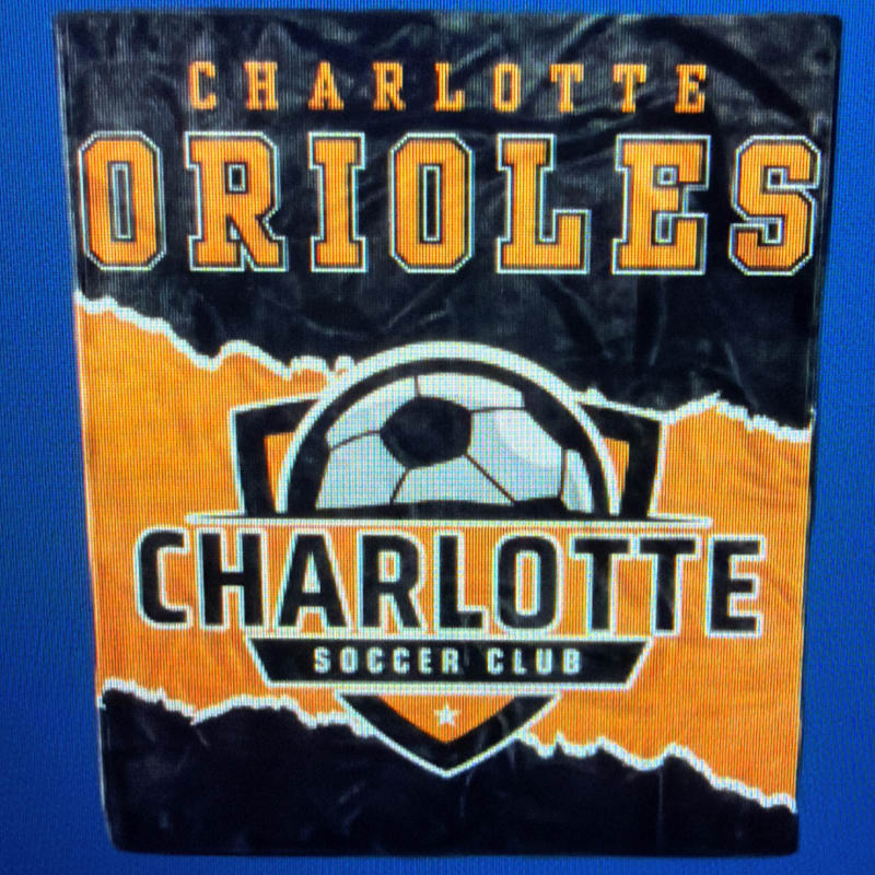 A logo for the Charlotte Orioles and Charlotte Soccer Club is featured in the foreground against a blue background.