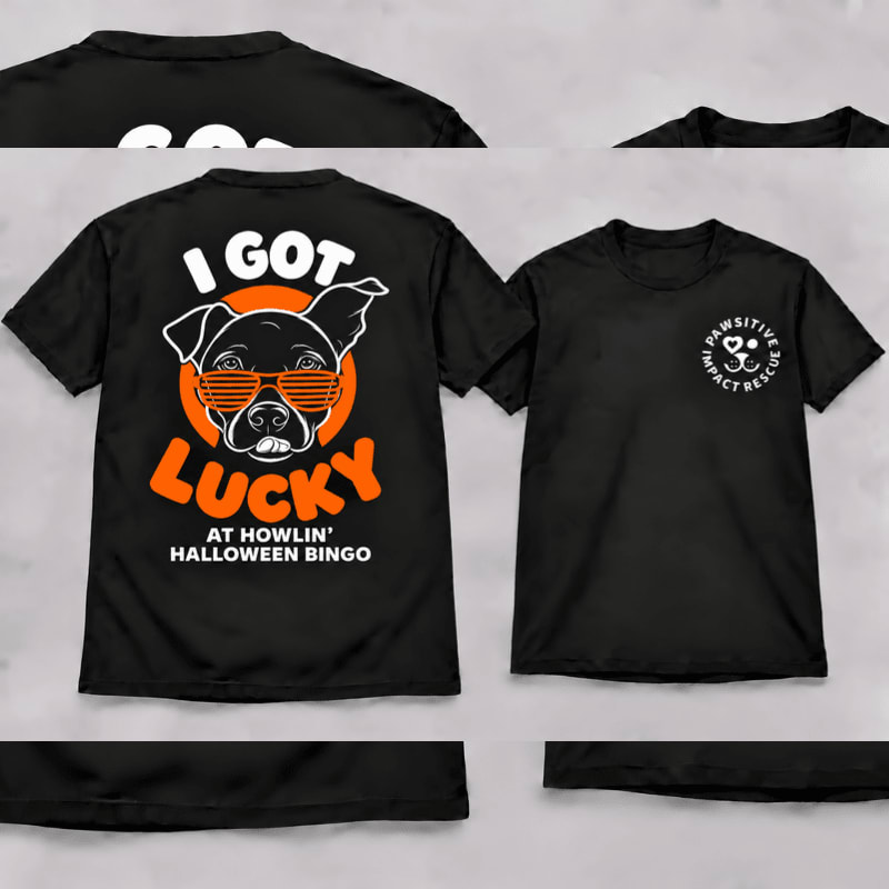 Two black t-shirts featuring a dog graphic and text on the back and a small logo on the front are displayed against a plain light gray background.