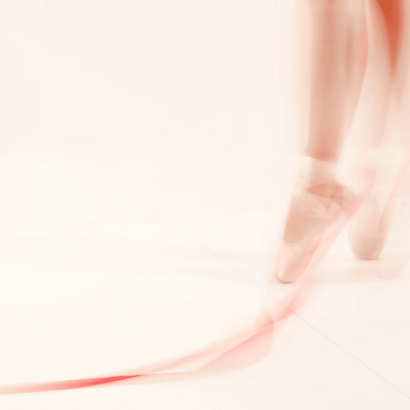 a blurry photo of a woman's legs and shoes