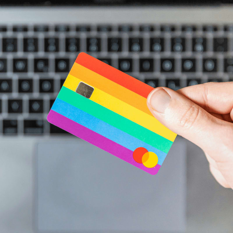 person holding yellow and pink card
