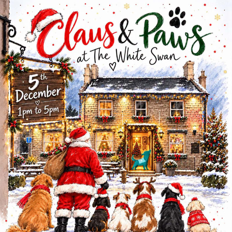 Santa Claus and a group of dogs sit in the snowy foreground facing a cozy, decorated stone cottage in the background.