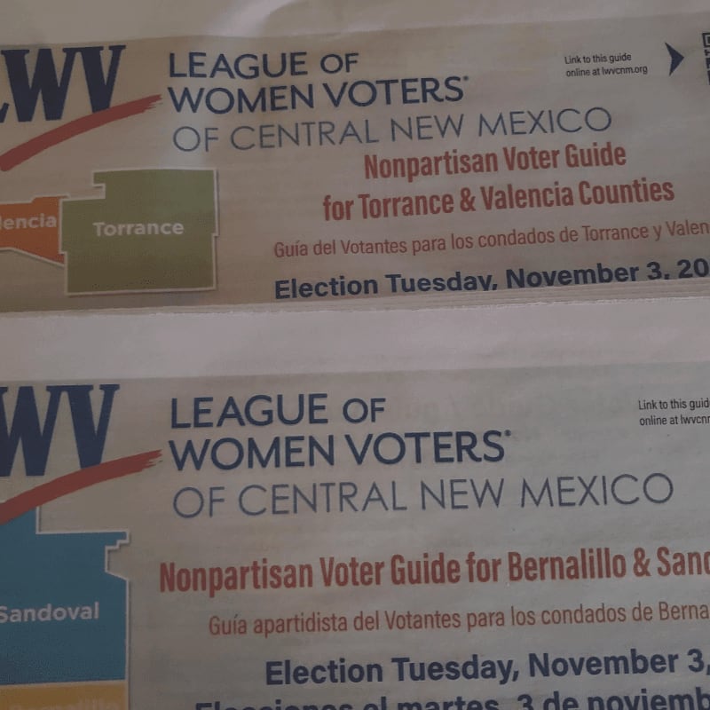 Two nonpartisan voter guides from the League of Women Voters of Central New Mexico are stacked on top of each other.