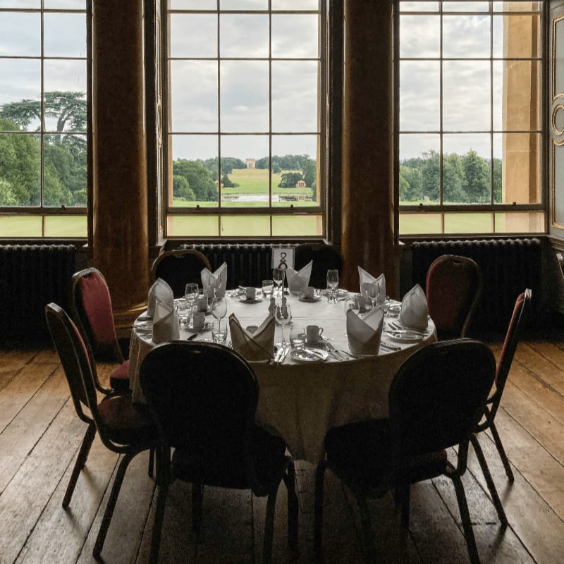a table set for a formal dinner in a large room