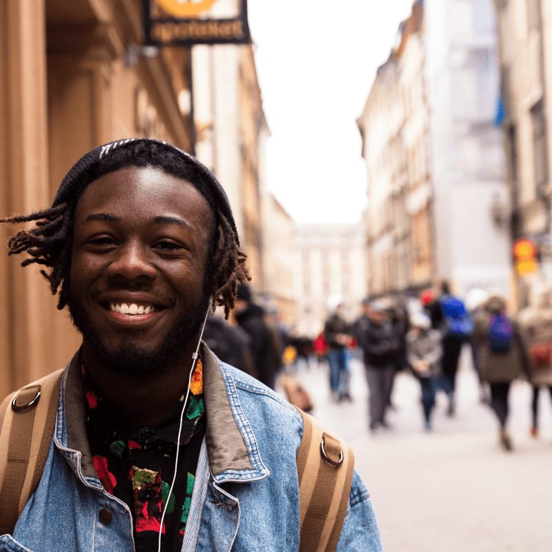selective focus of man smiling near building