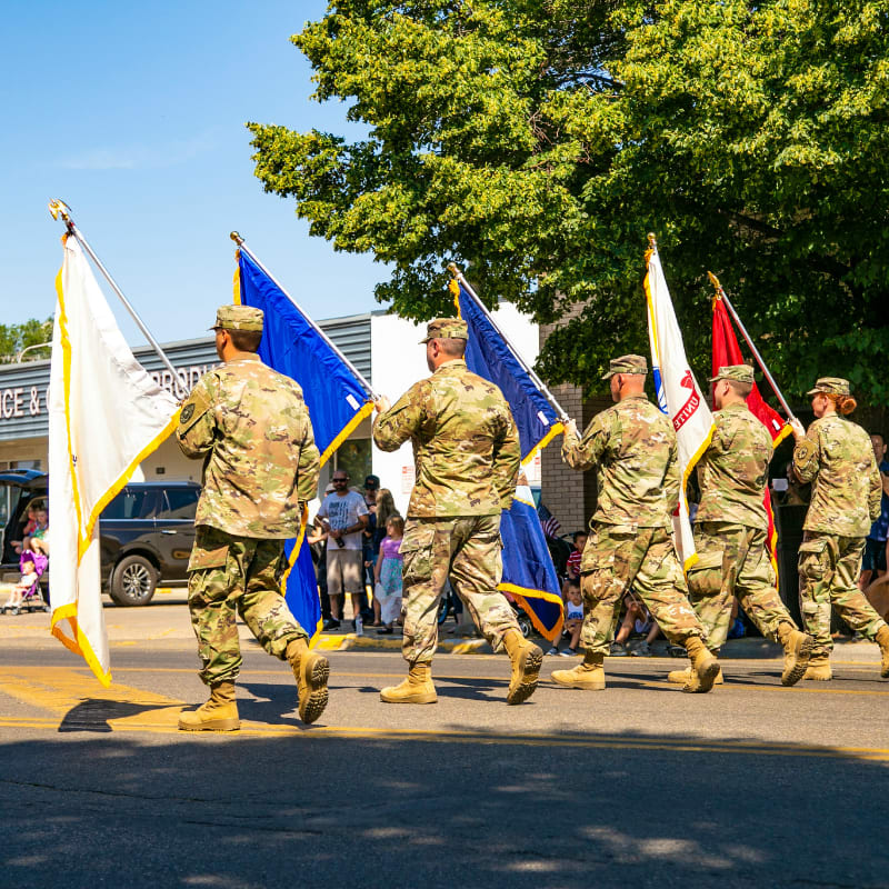 soldiers in brown and green camouflage uniform standing on road during daytime