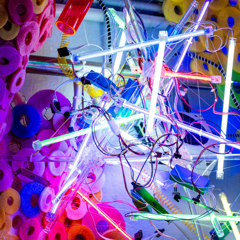 Abstract sculpture with colorful lights and wires
