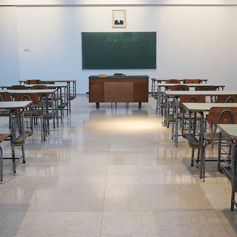 empty classroom with desks and chalkboard