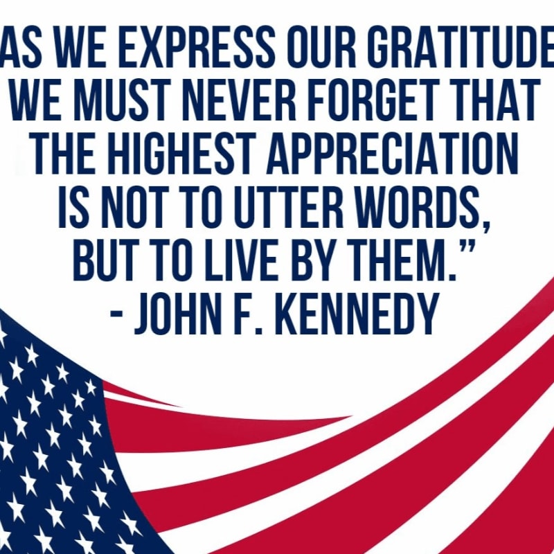 A quote by John F. Kennedy is written in blue text across a white background, with a waving American flag flowing across the bottom foreground.